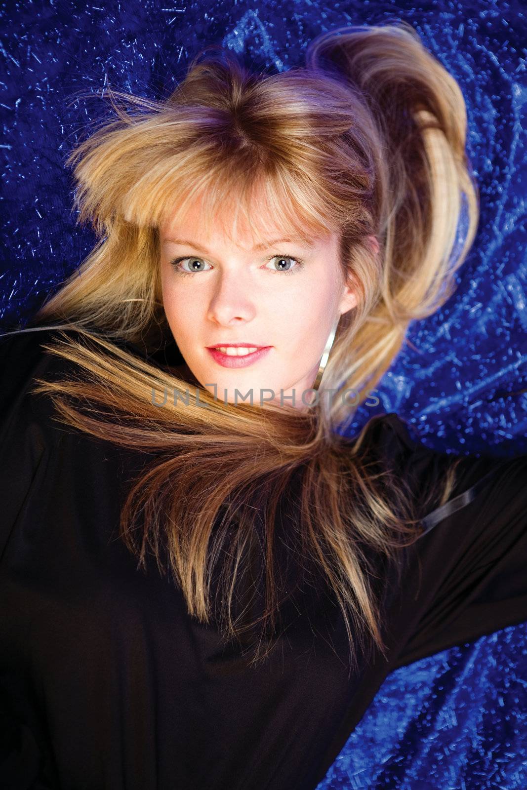 Pretty blond girl on blue background