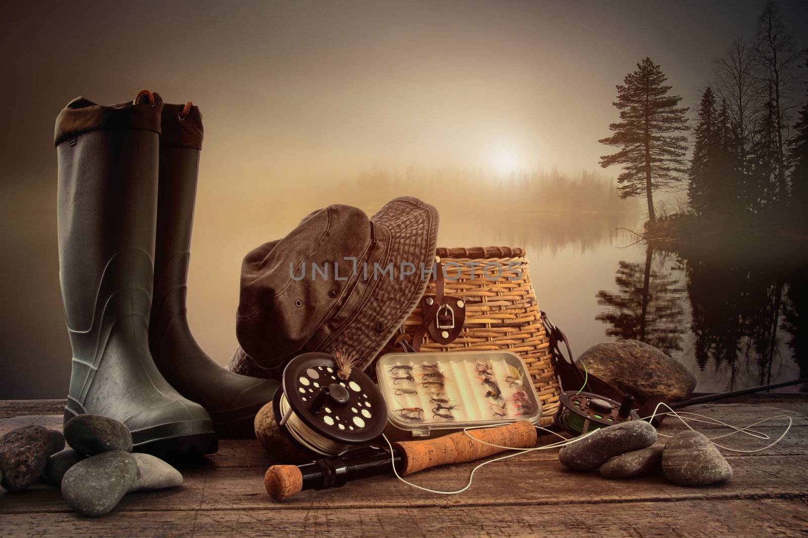 Fly fishing equipment on deck with view of a misty lake by Sandralise