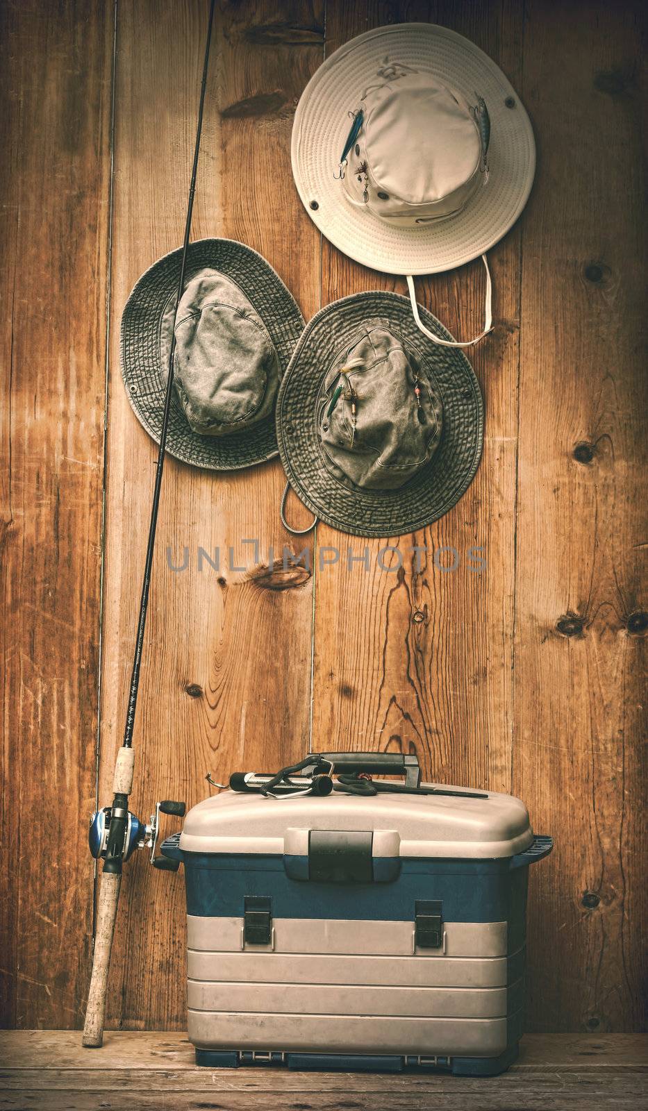 Hats hanging on wall with fishing equipment by Sandralise