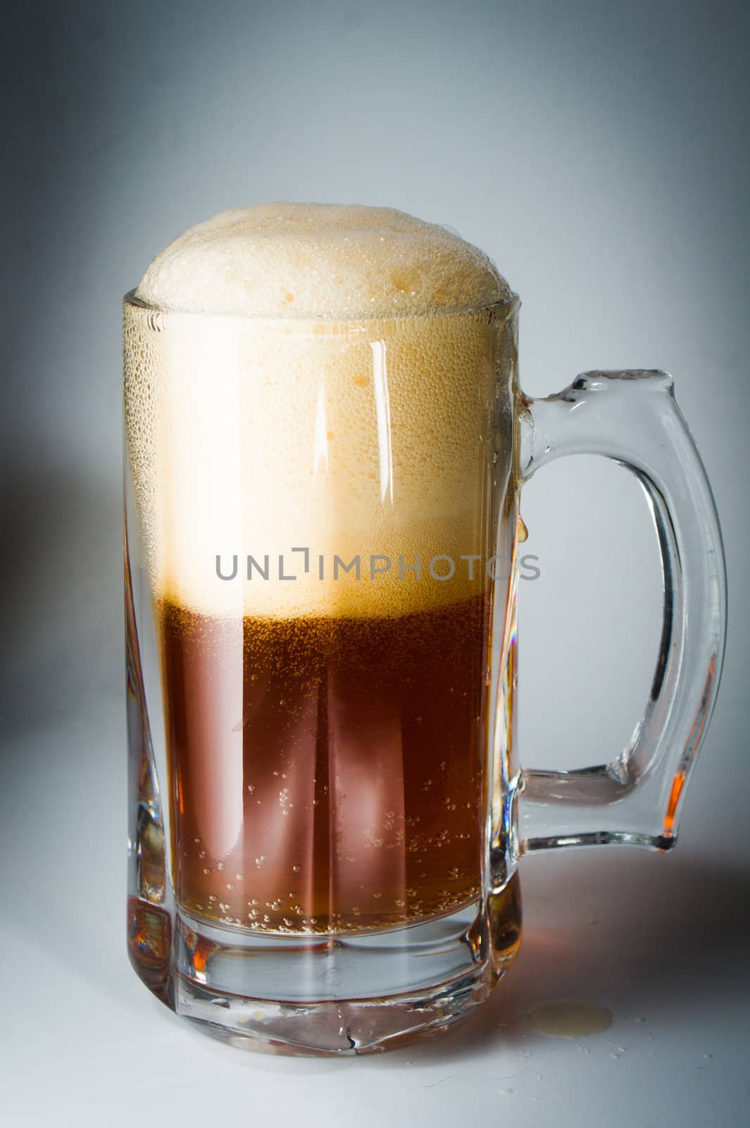 Beer glass full of cold dark beer. Isolated