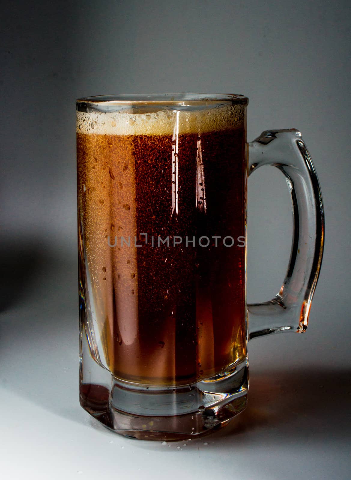 Beer glass full of cold dark beer. Isolated