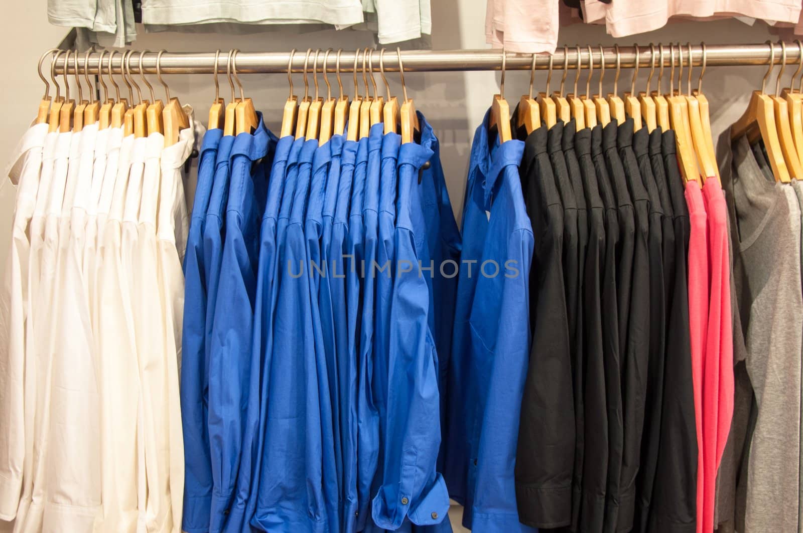 fashion clothing on hangers for display in the shop