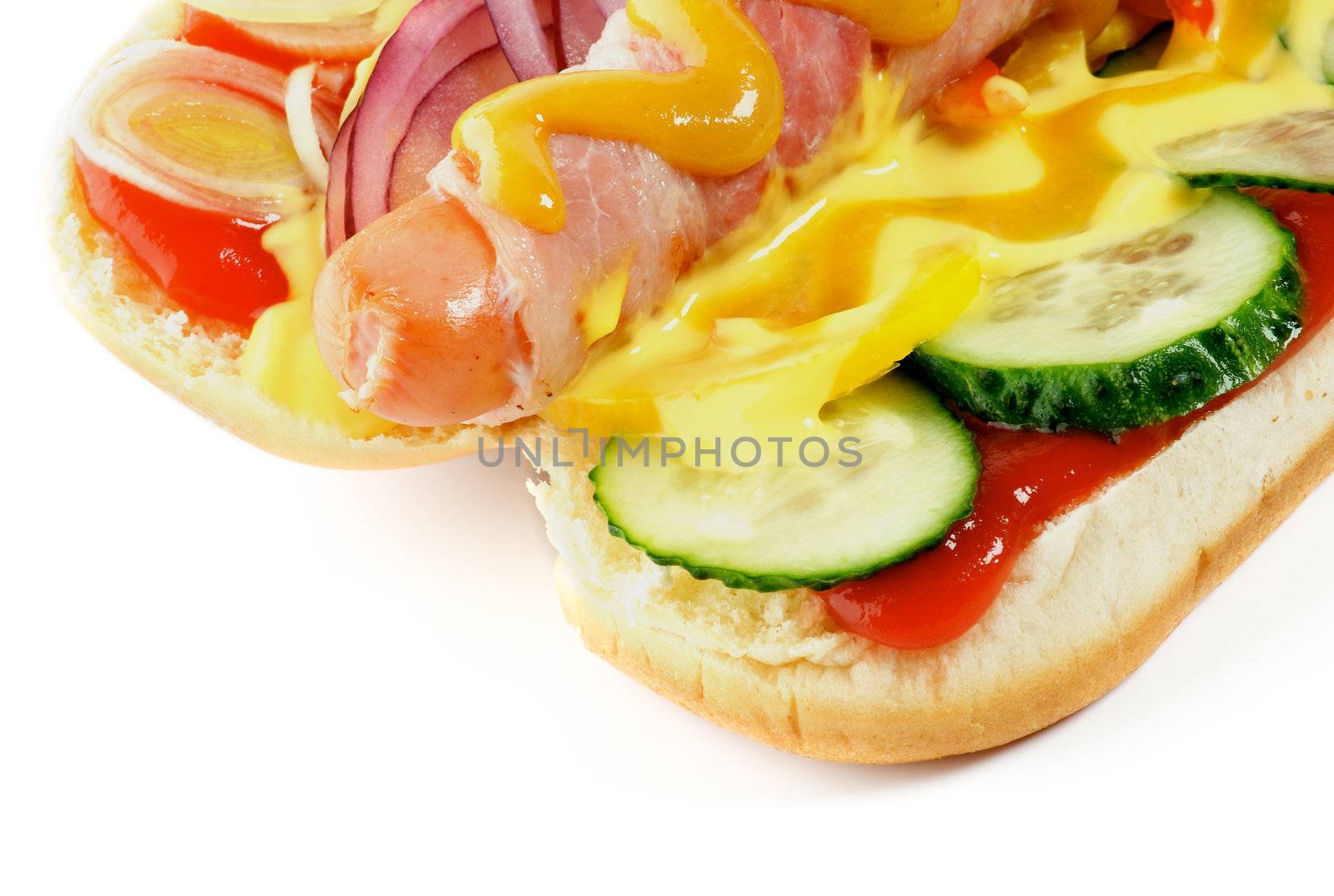 Inside View of Hot Dog with Sausage, Bacon, Cucumber, Onion, Ketchup and Mustard close up isolated on white background