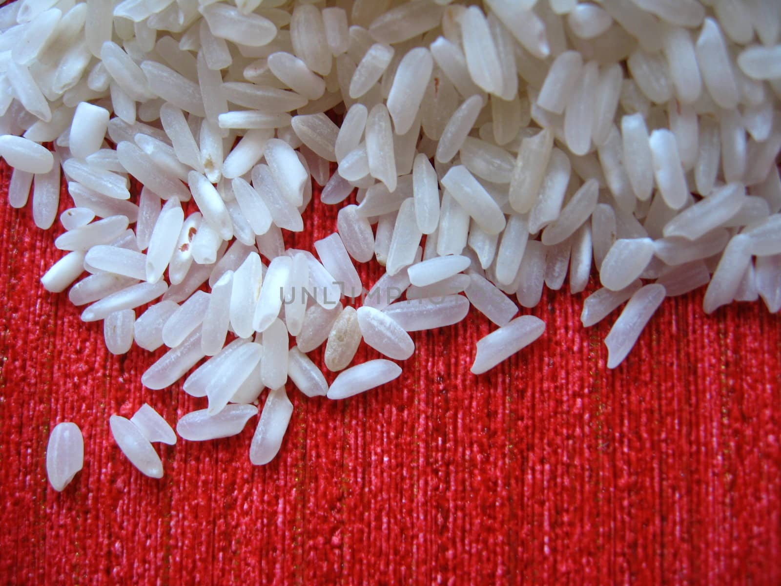scattered rice on a red background by alexmak