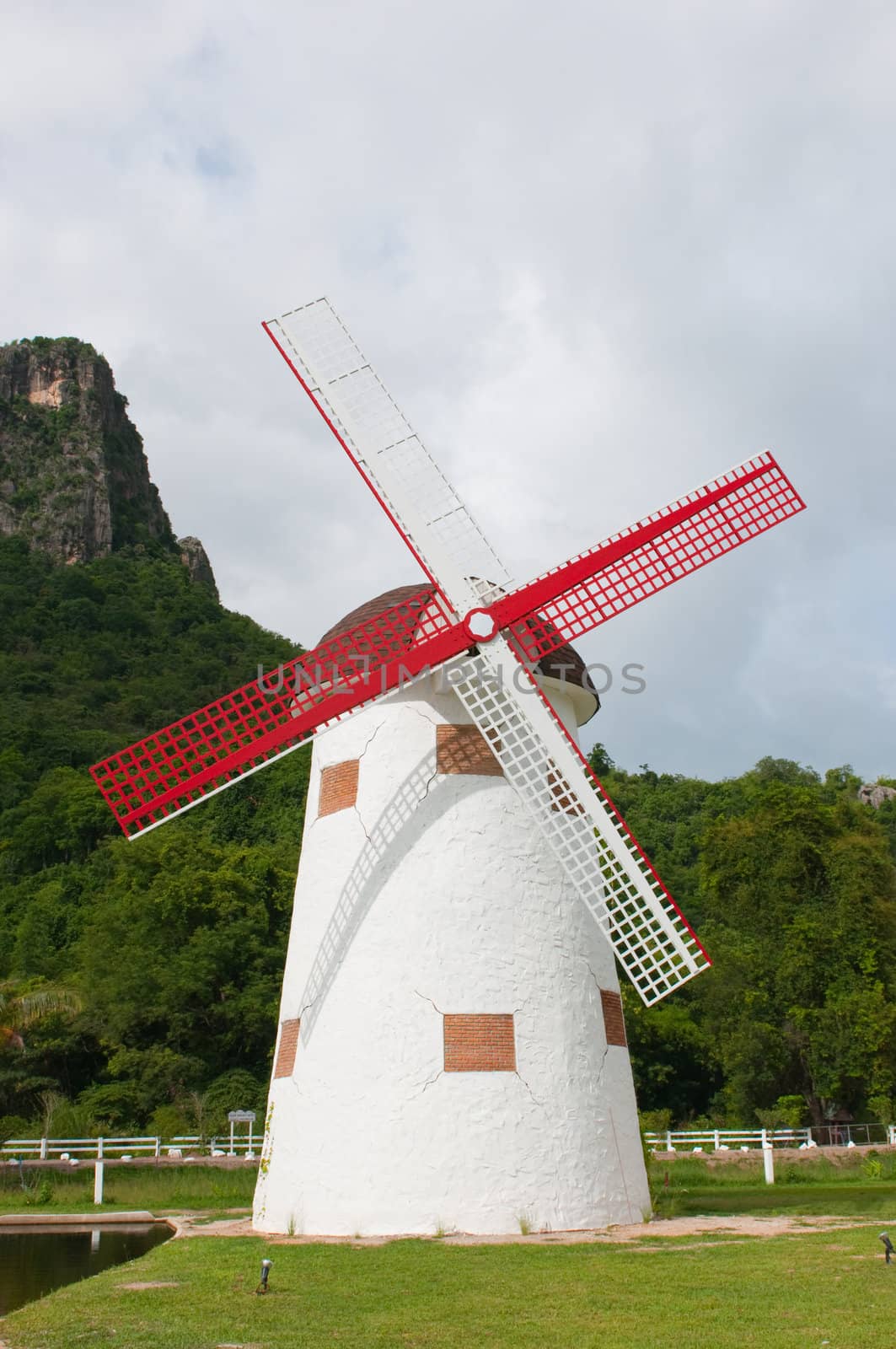 red vintage wind mill in the park 