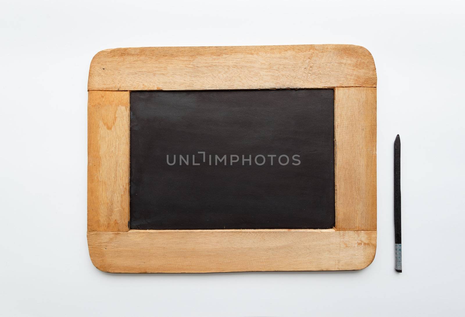 Old vintage  wooden frame blank slate and pencil isolated on white background