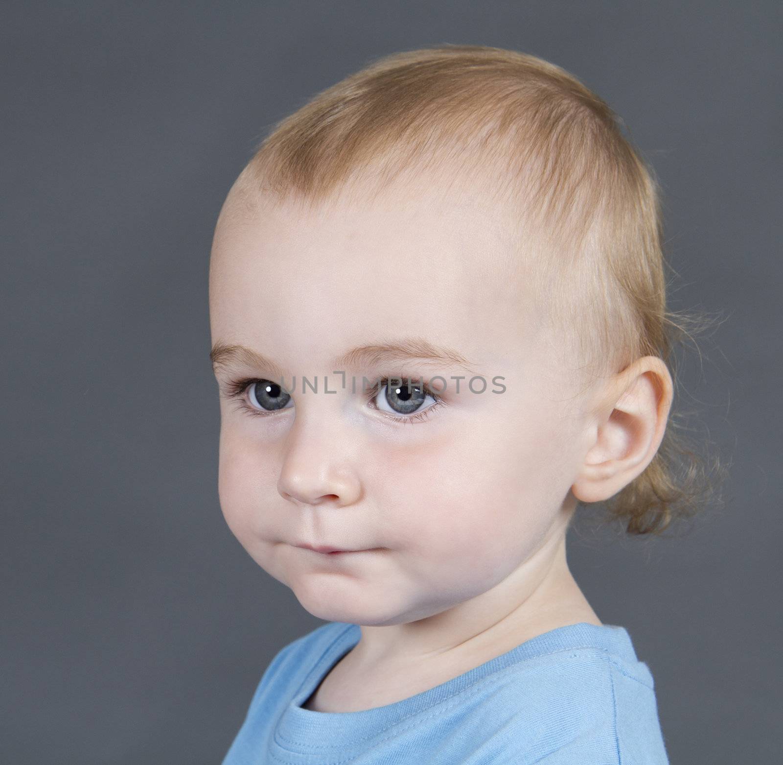 portrait of young child on grey background