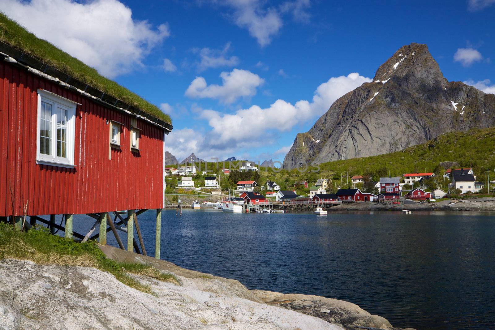 Typical red rorbu hut with sod roof in a picturesque town of Reine on Lofoten islands in Norway