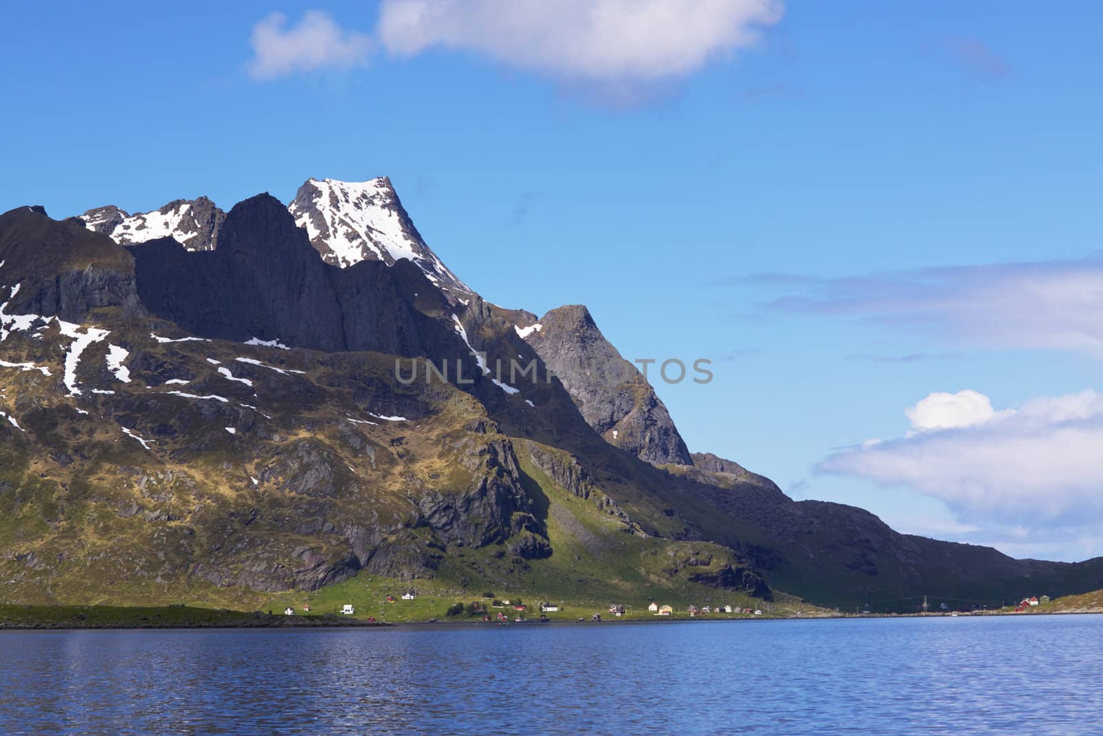 Dramatic snowy mountain peaks around Reinefjorden on Lofoten islands in Norway