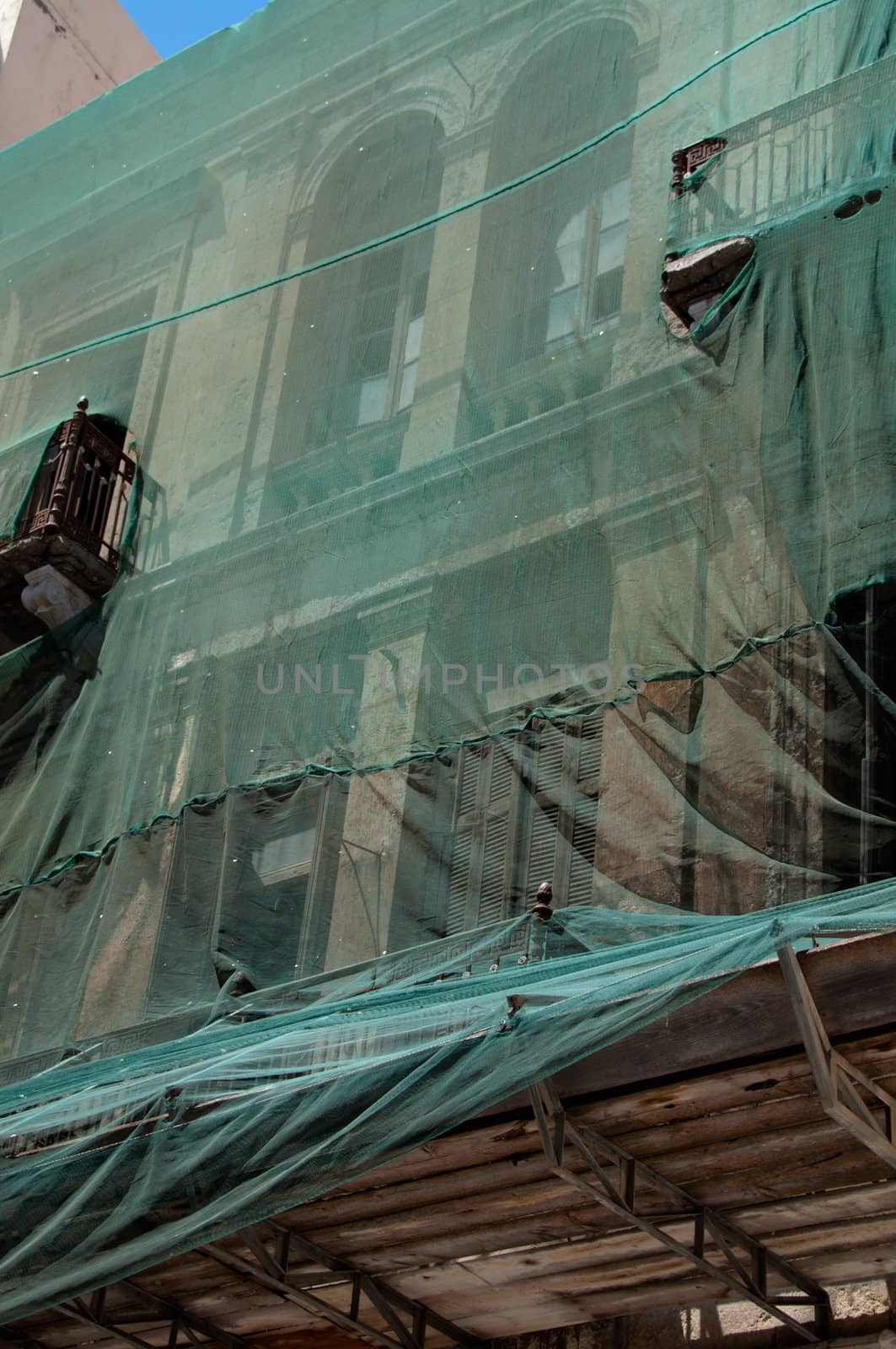 Scaffolding covering a luxurious old building under restoration on Crete Island, Greece