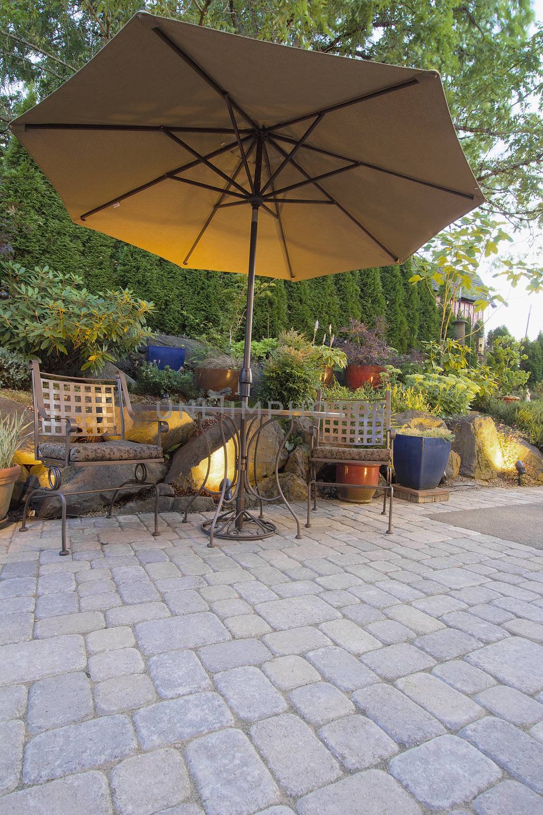 Garden Furniture Table Chairs and Umbrella on Pavers Patio