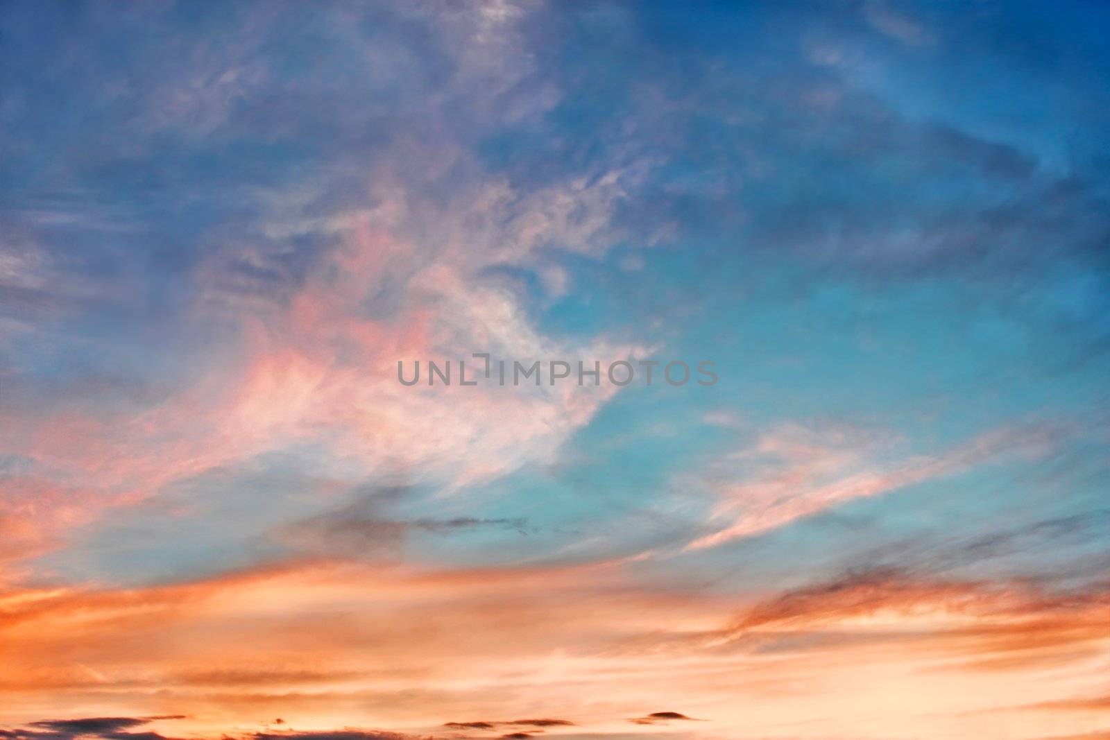 Multicolor clouds at sunset in the fine summer evening