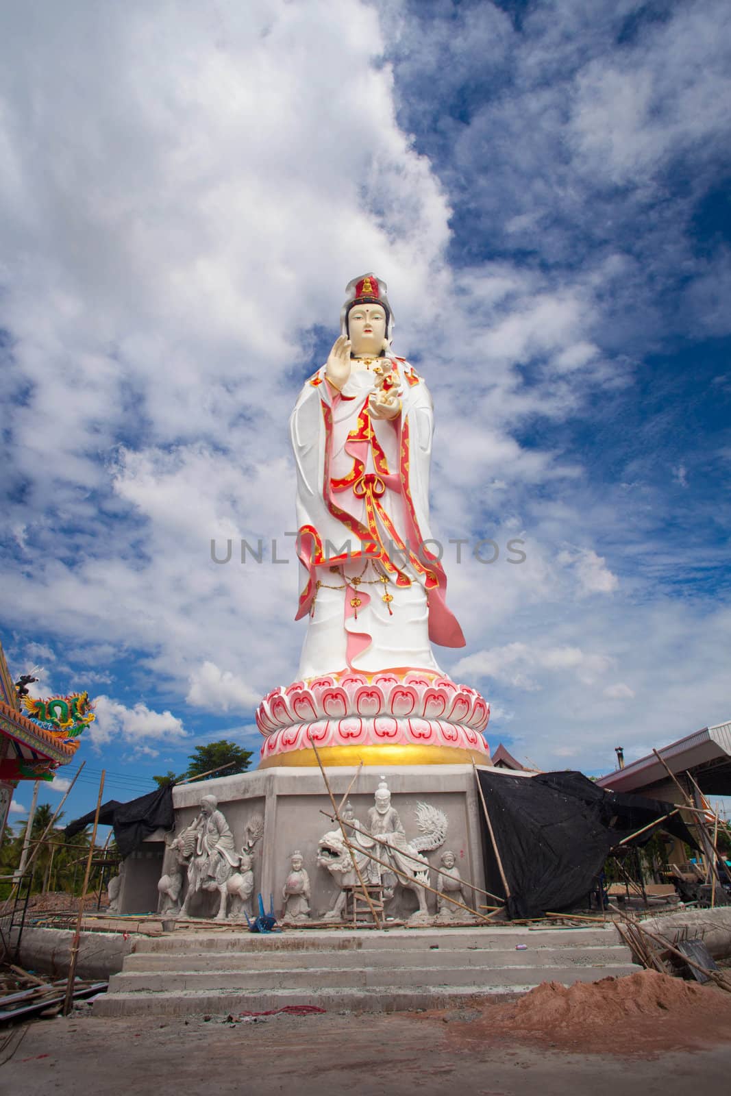 Kuan Yin who is white with blue sky