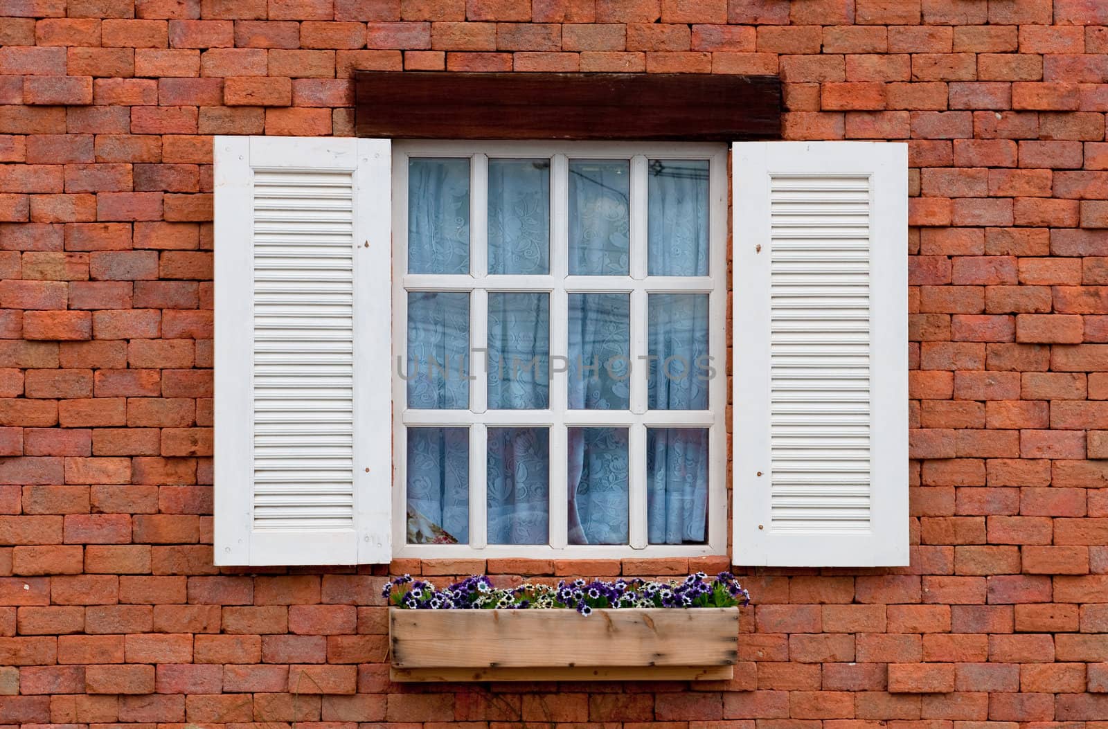 Vintage white window on red brick wall 