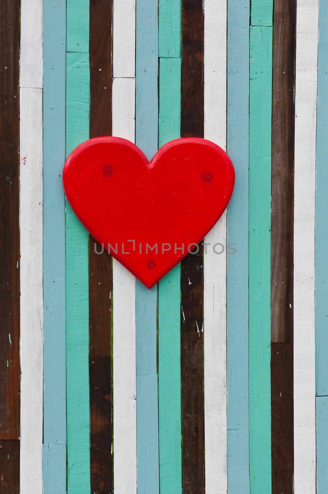 red heart on colorful of old wood background 
