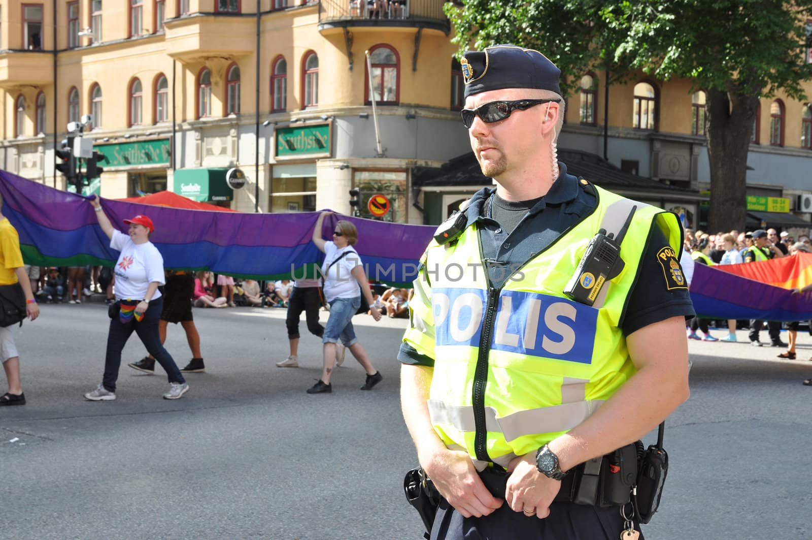 STOCKHOLM, SWEDEN - AUGUST 4: An unidentified policeman protects people taking part in Pride Parade 2012 to support gay rights on August 4, 2012 in Stockholm Sweden.