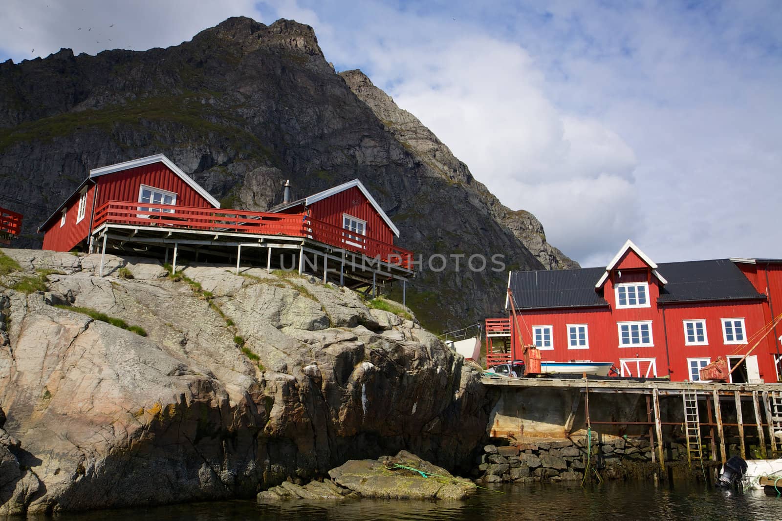 Traditional red fishing rorbu huts built on rocks on Lofoten Islands, Norway