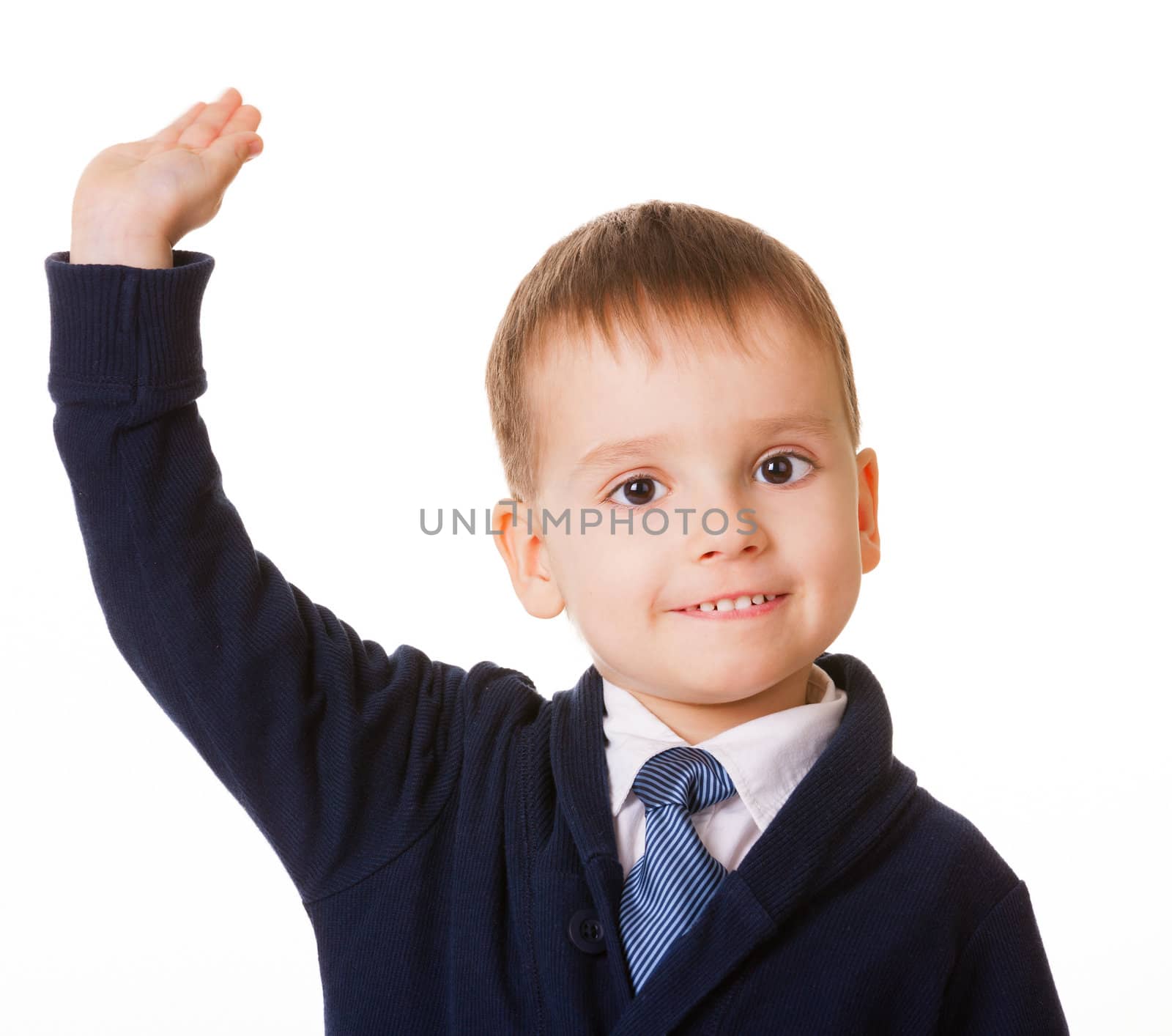 Small schoolboy raises his hand for answer, isolated on white background