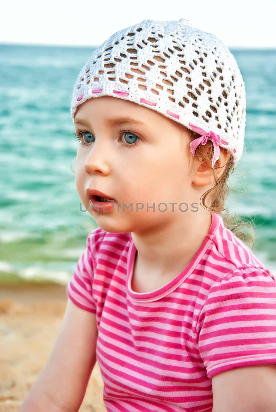 Portrait of cute little girl on the beach