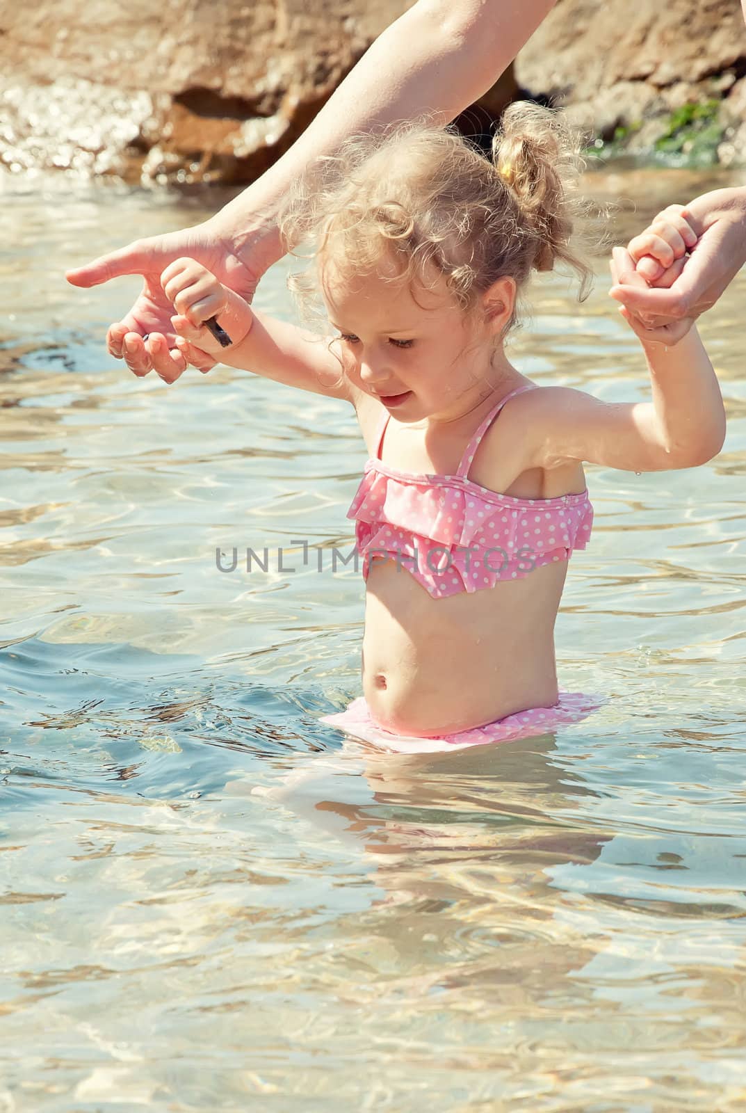 Cute little girl having fun in the sea by dmitrimaruta