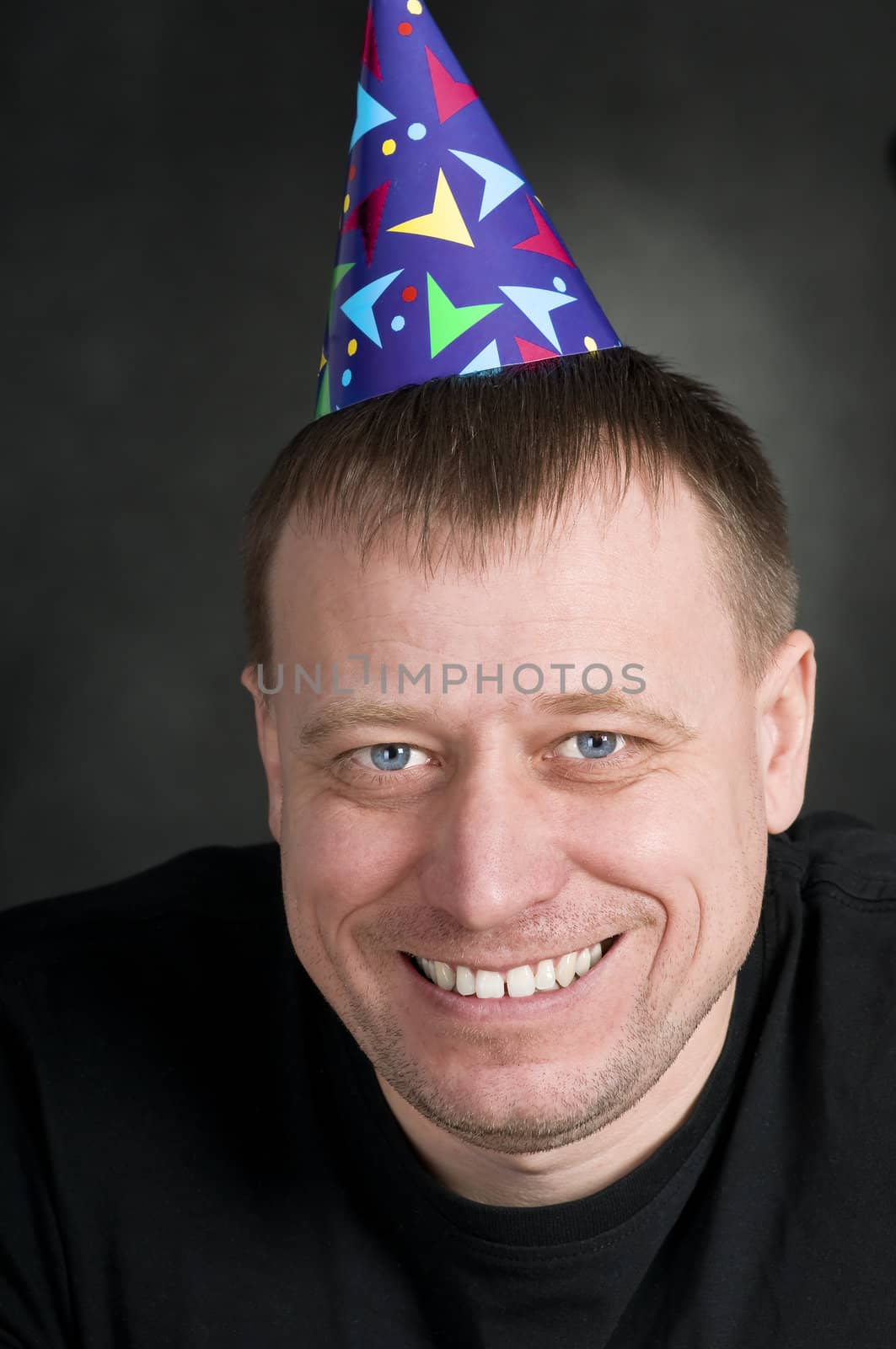 a smiling man in the festive hood on the dark background