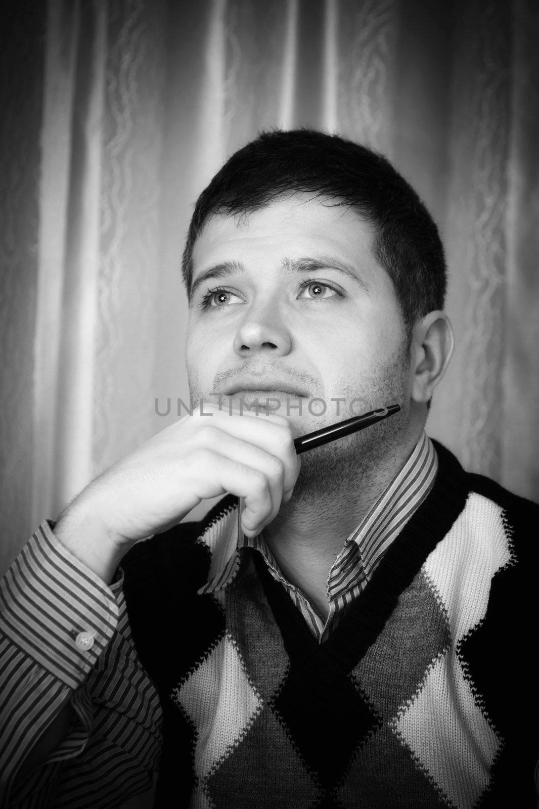 Young man with a look of daydreaming on his face.