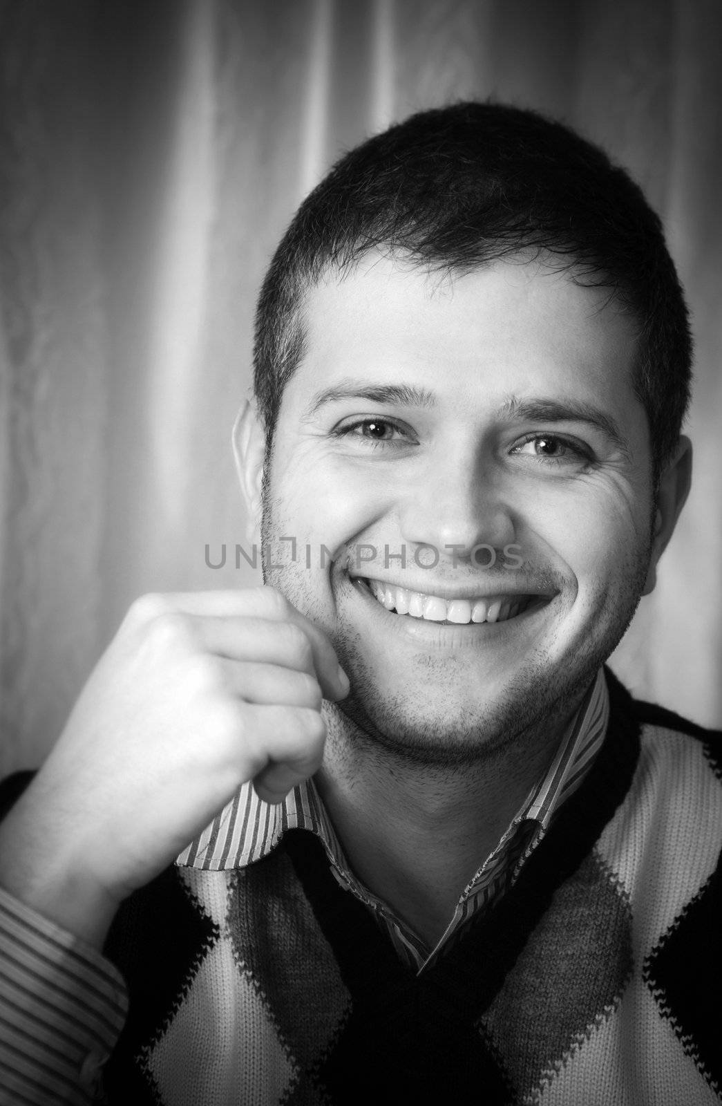 Black and white portrait of a happy young man