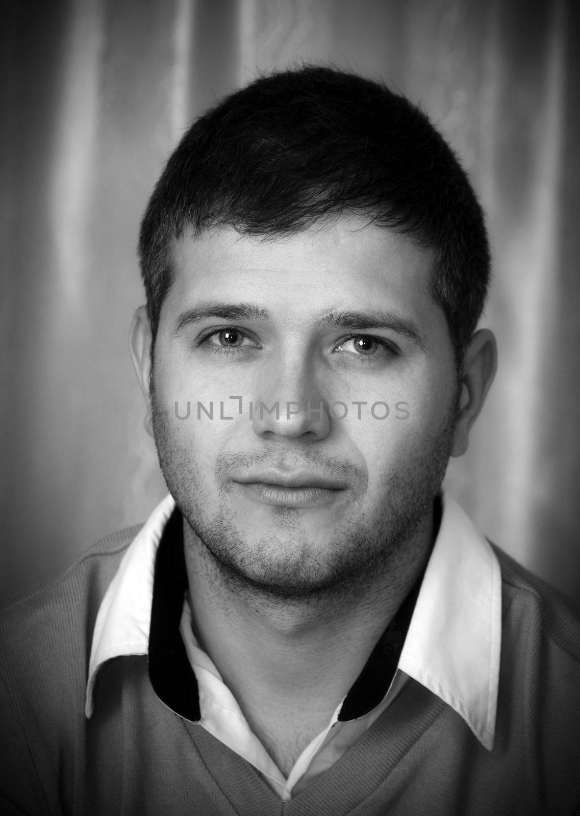 Black and white portrait of young man looking at camera