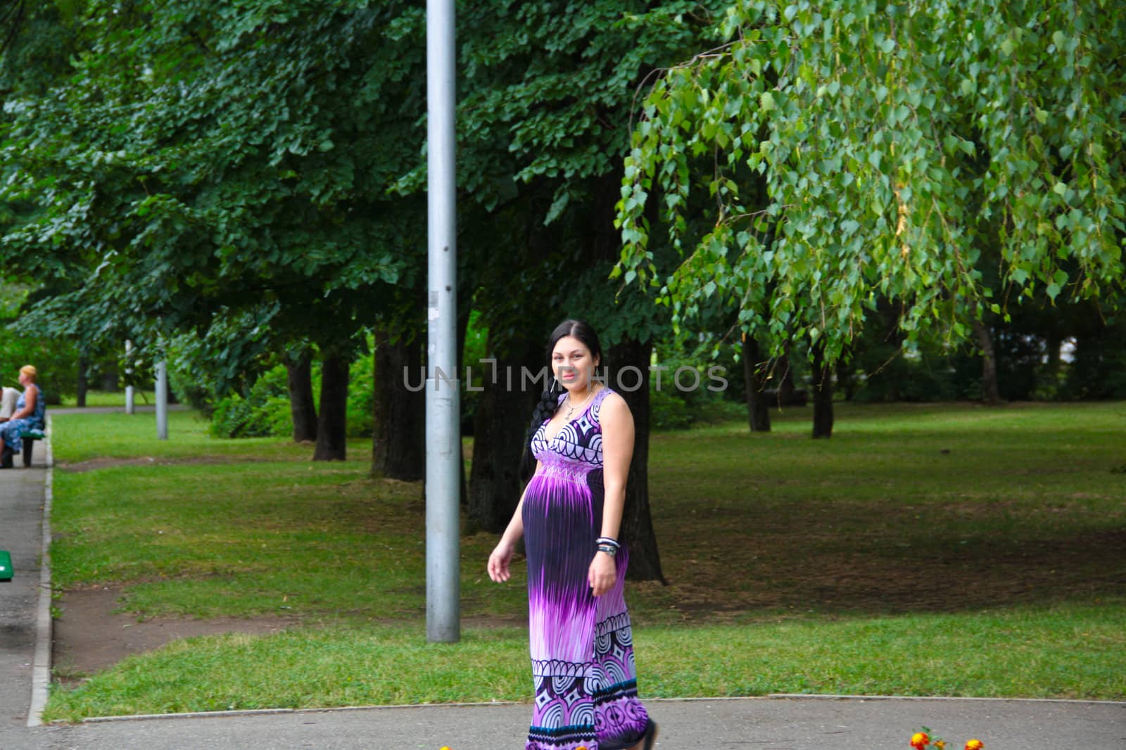 The pregnant girl on walk in city park