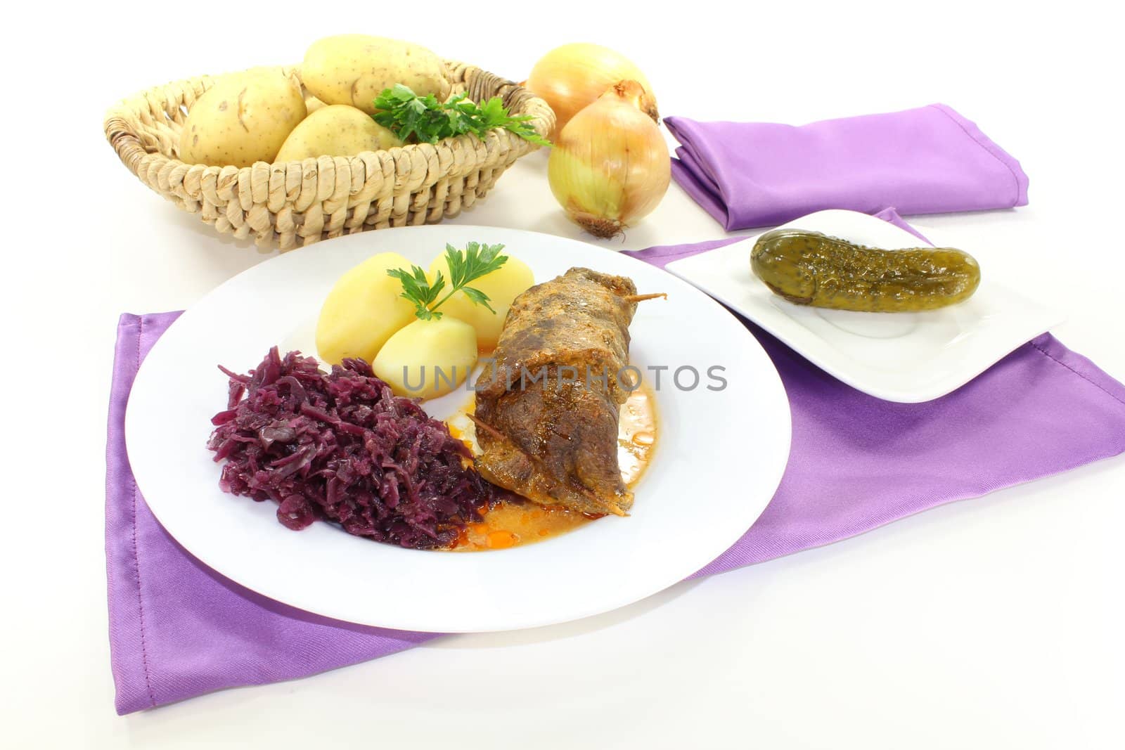 beef rolls stuffed with onions, bacon and pickles on a light background