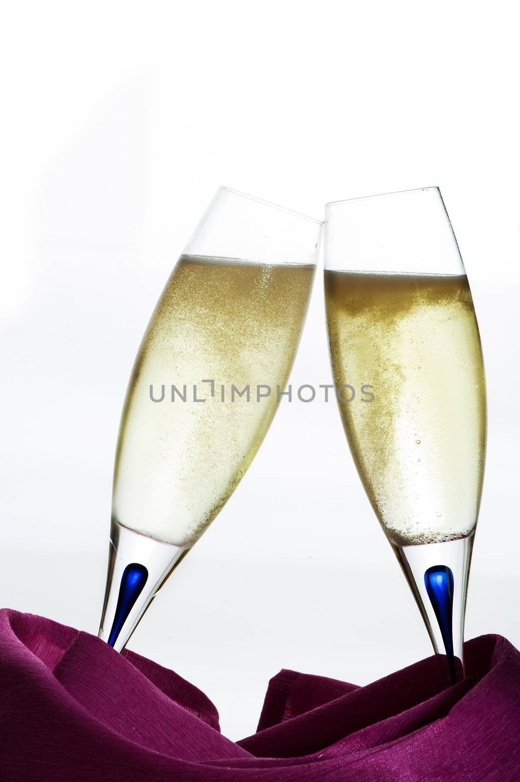Two glasses of champagne on white background