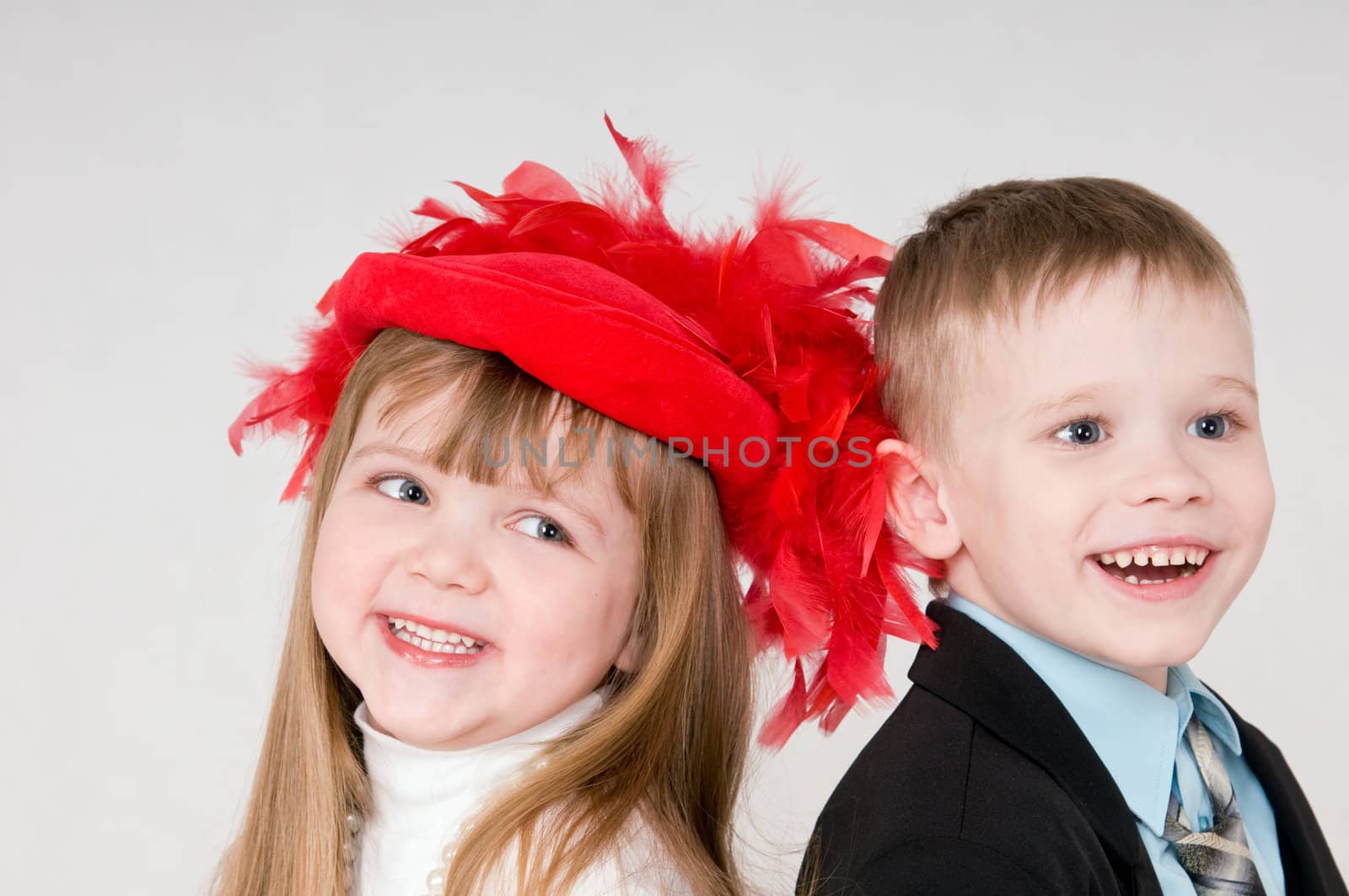 smiling boy and a girl is stand back to back