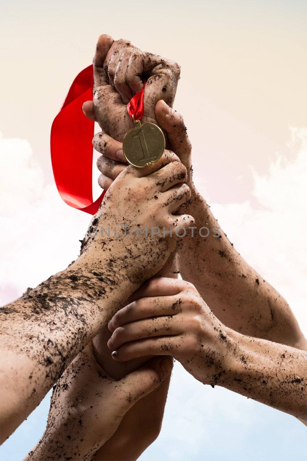 hands held together to win a medal, team work