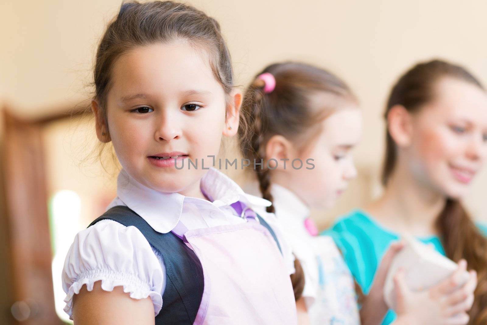 Portrait of Asian girl in apron interested in painting at an art school