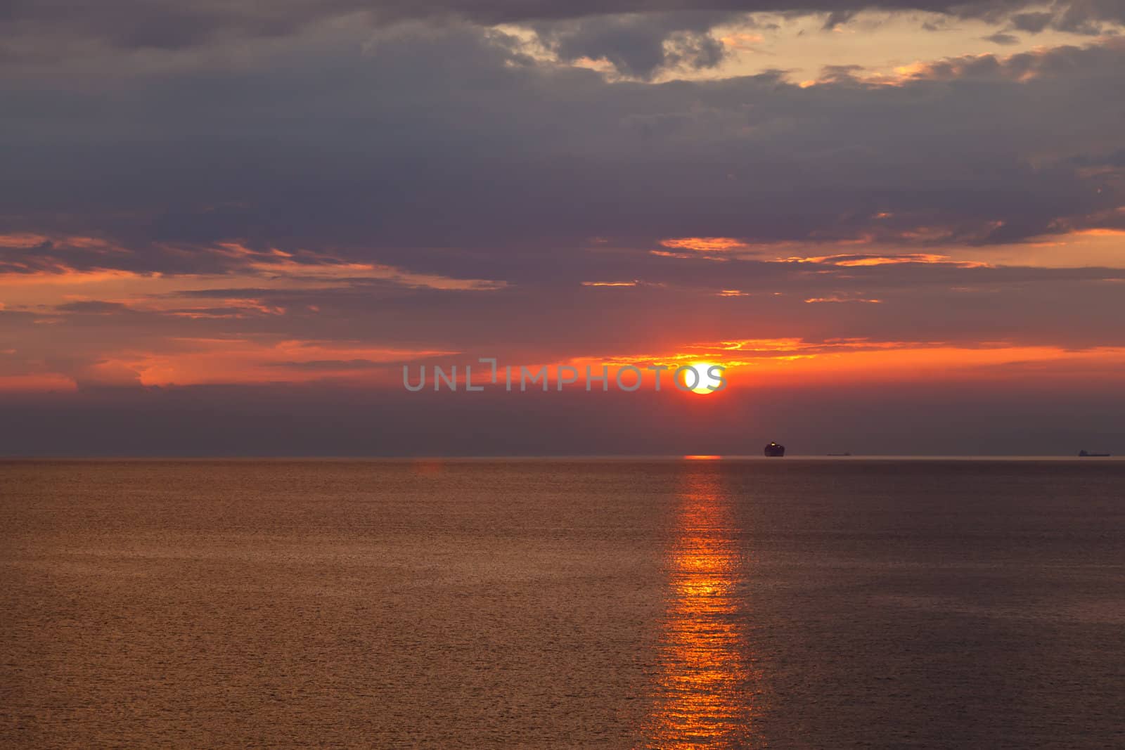 Lonely Ship and Beautiful Sunset near Genoa in Italy