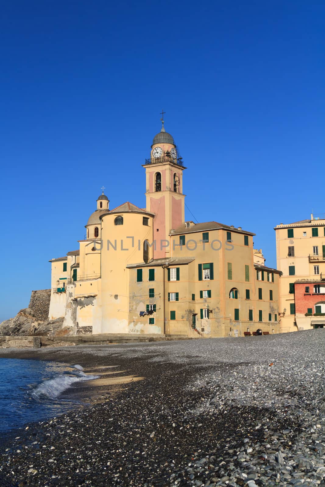 beach and church in Camogli, famous small town in Mediterranean sea, Italy