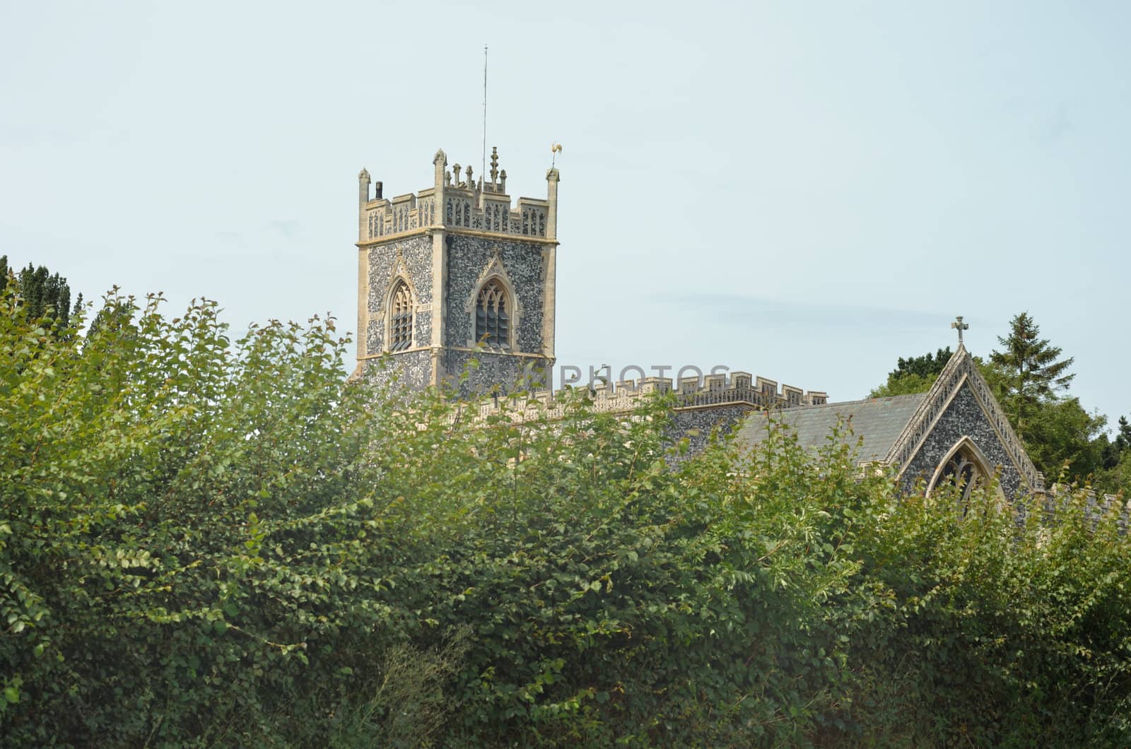 Isolated Parish church through trees by pauws99