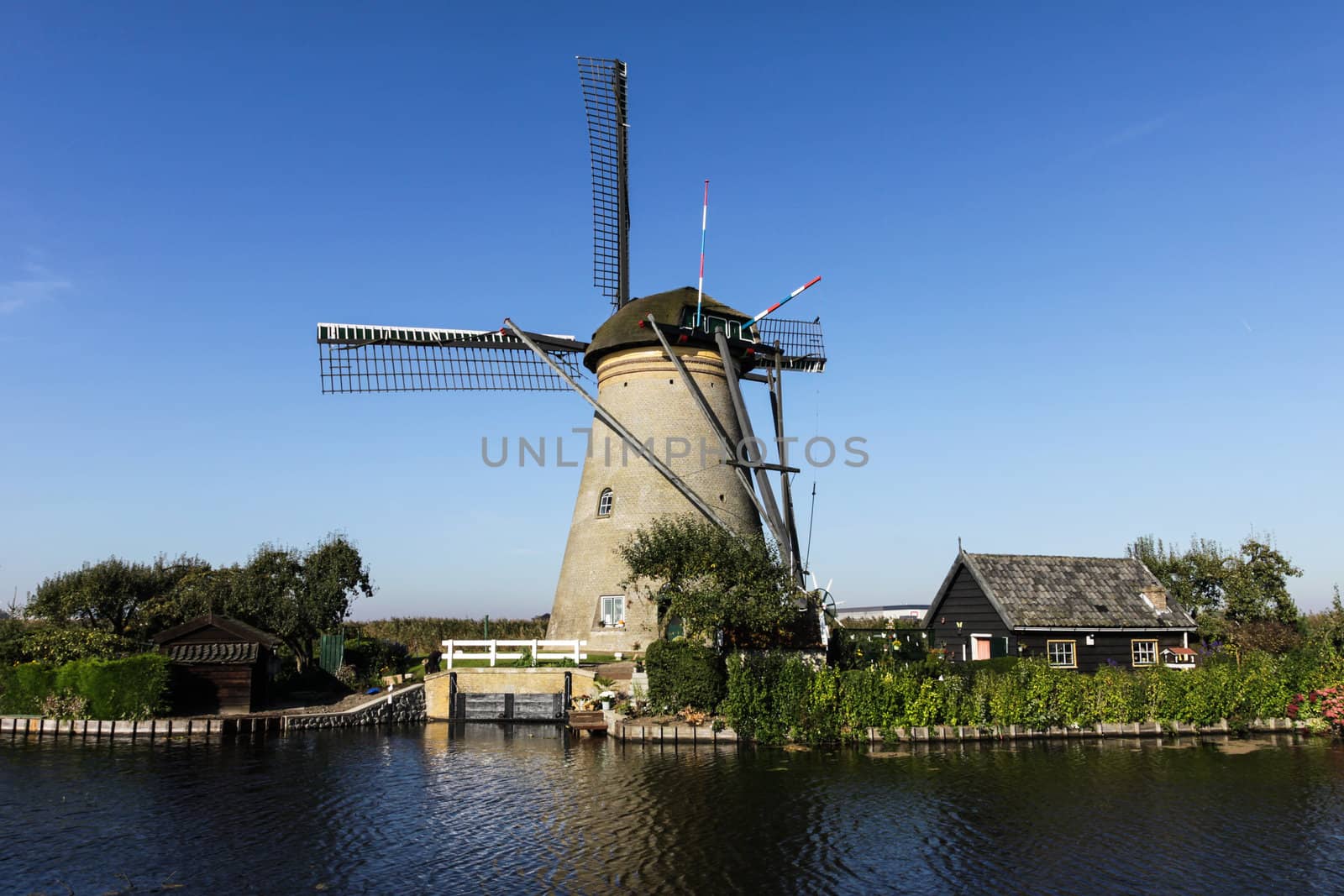 Windmills and  house on the canal in Holland