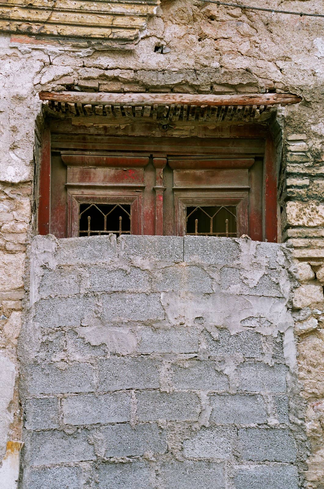 Bricked up vintage door and grungy wall. Abandoned house exterior.