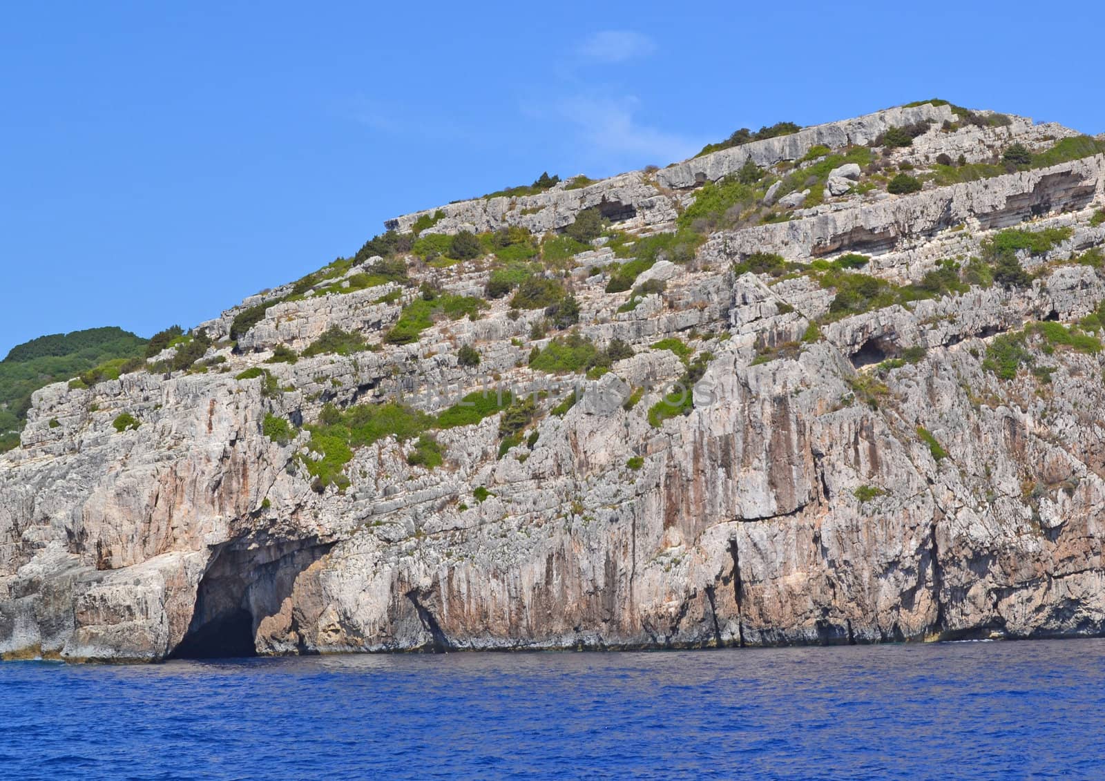 The rocky coast washed by the warm sea