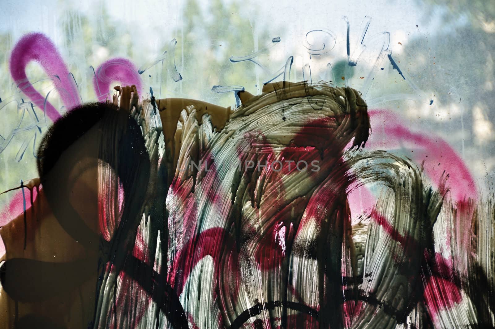 Dusty window glass smudged with dripping paint. Abstract background.