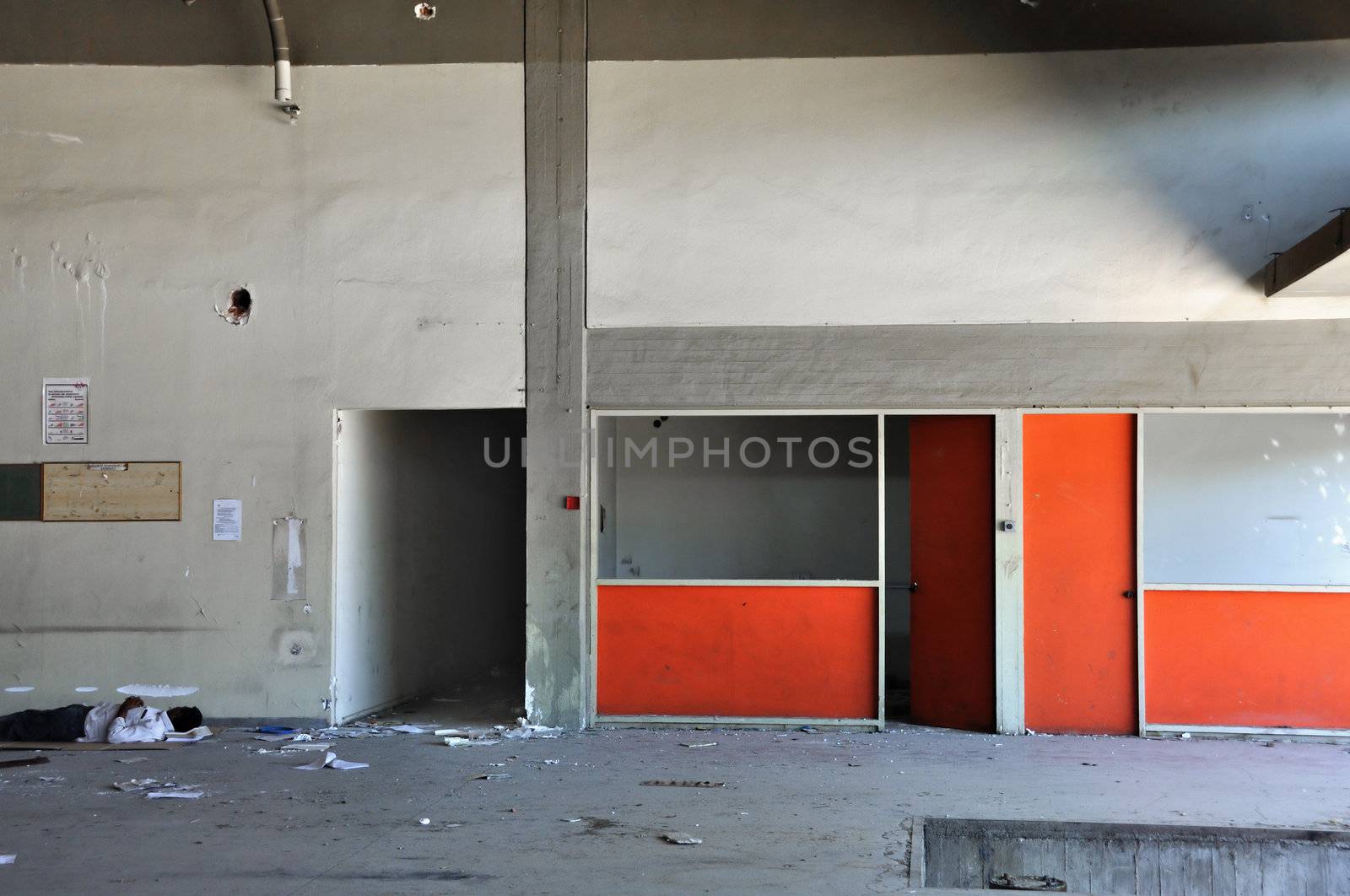 ATHENS, GREECE, SEPTEMBER 2011. Young immigrant sleeps on the dirty floor of an abandoned factory.