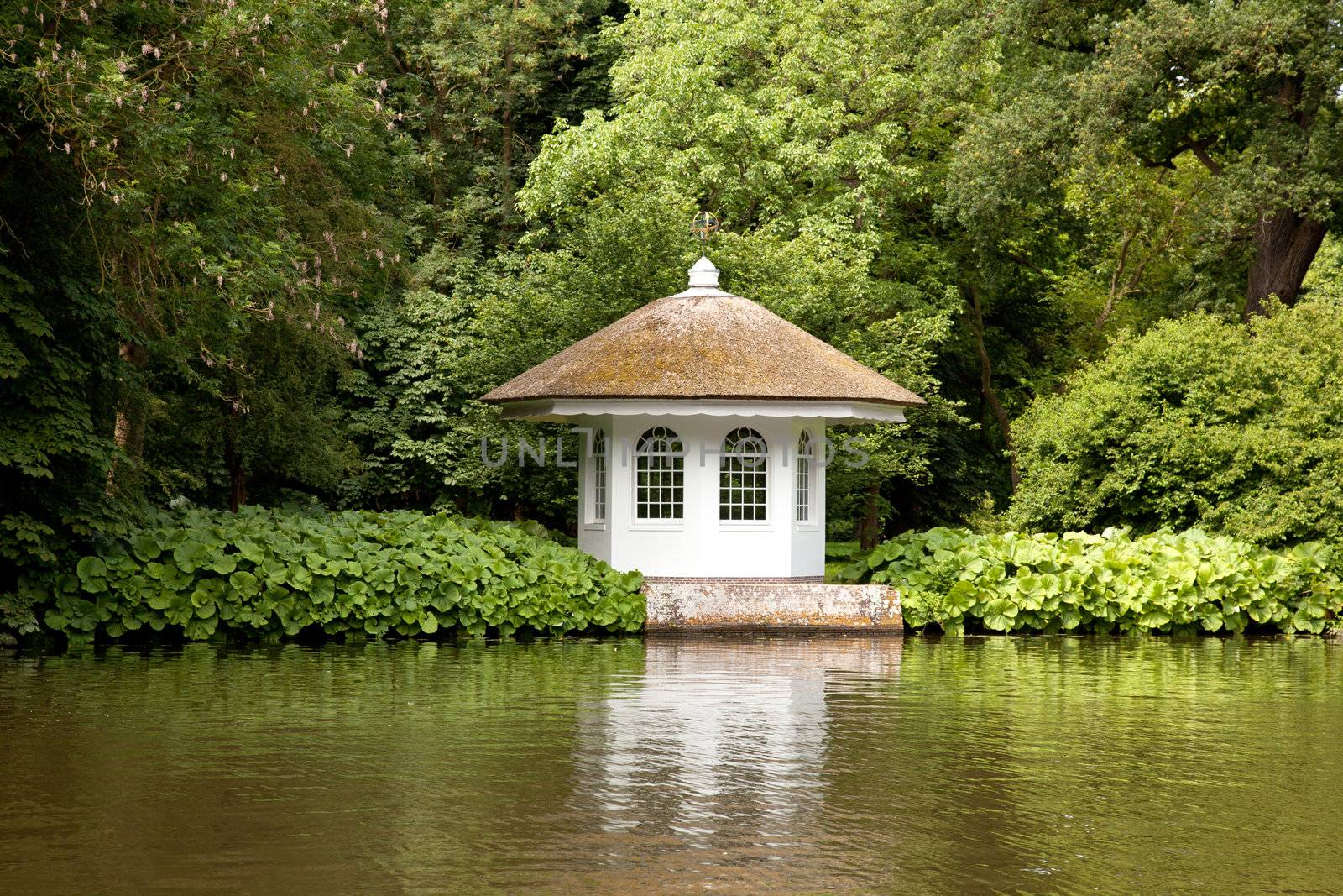 little house in rich garden on the embankment of the river by ahavelaar