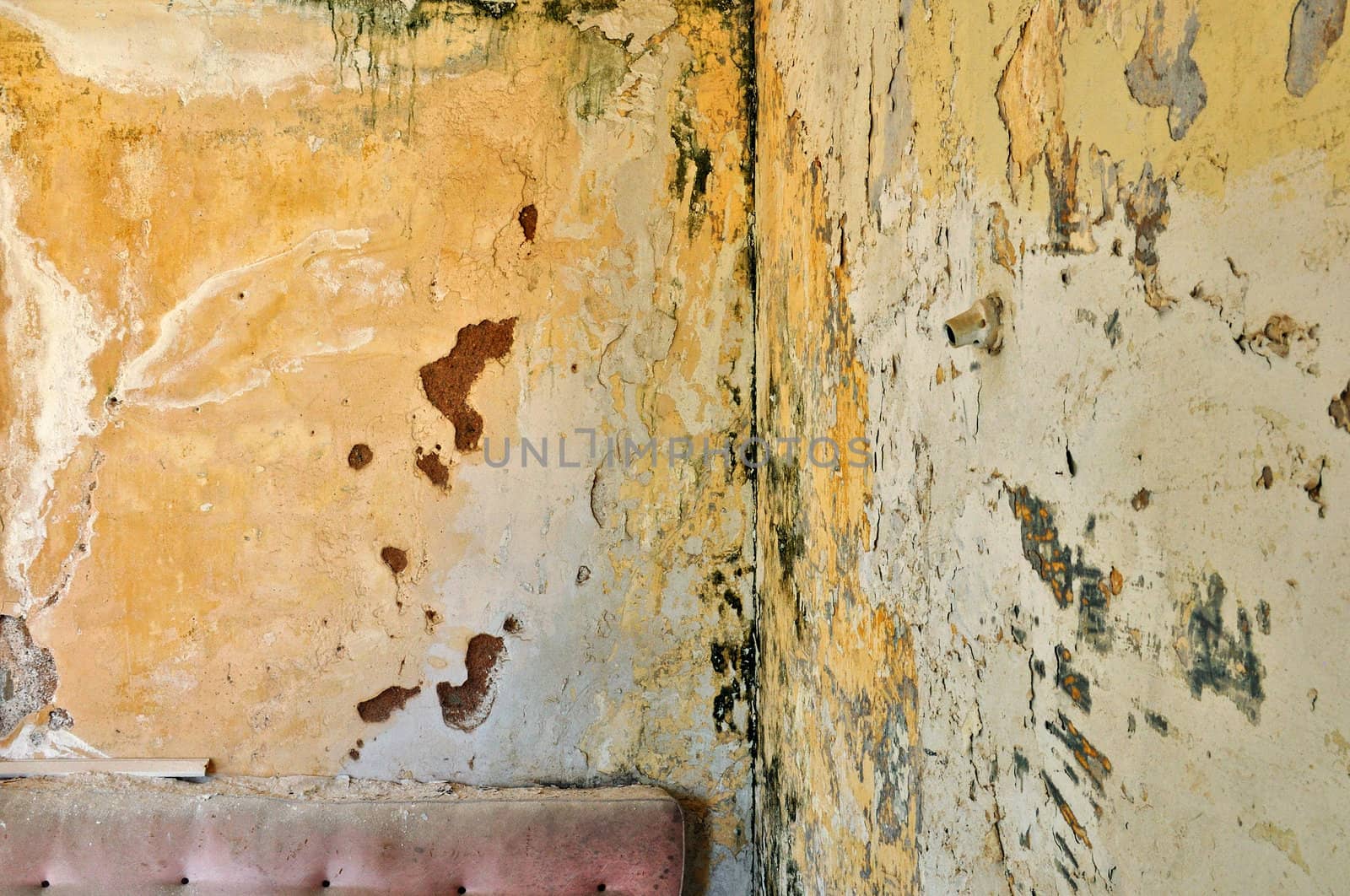 Peeling paint grunge wall in abandoned interior. Background texture.