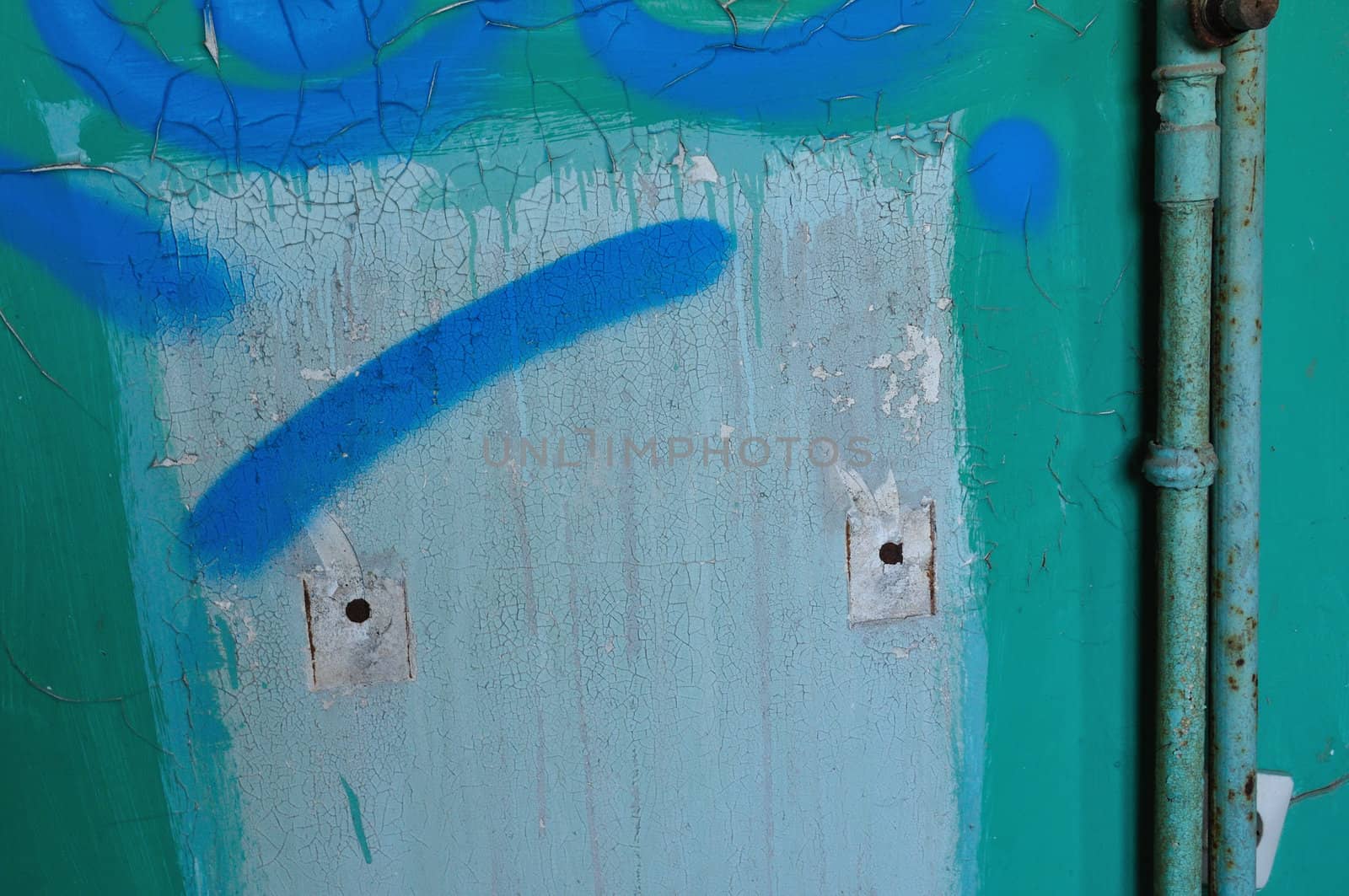 Peeling paint wall and rusty pipes. Grunge background texture.