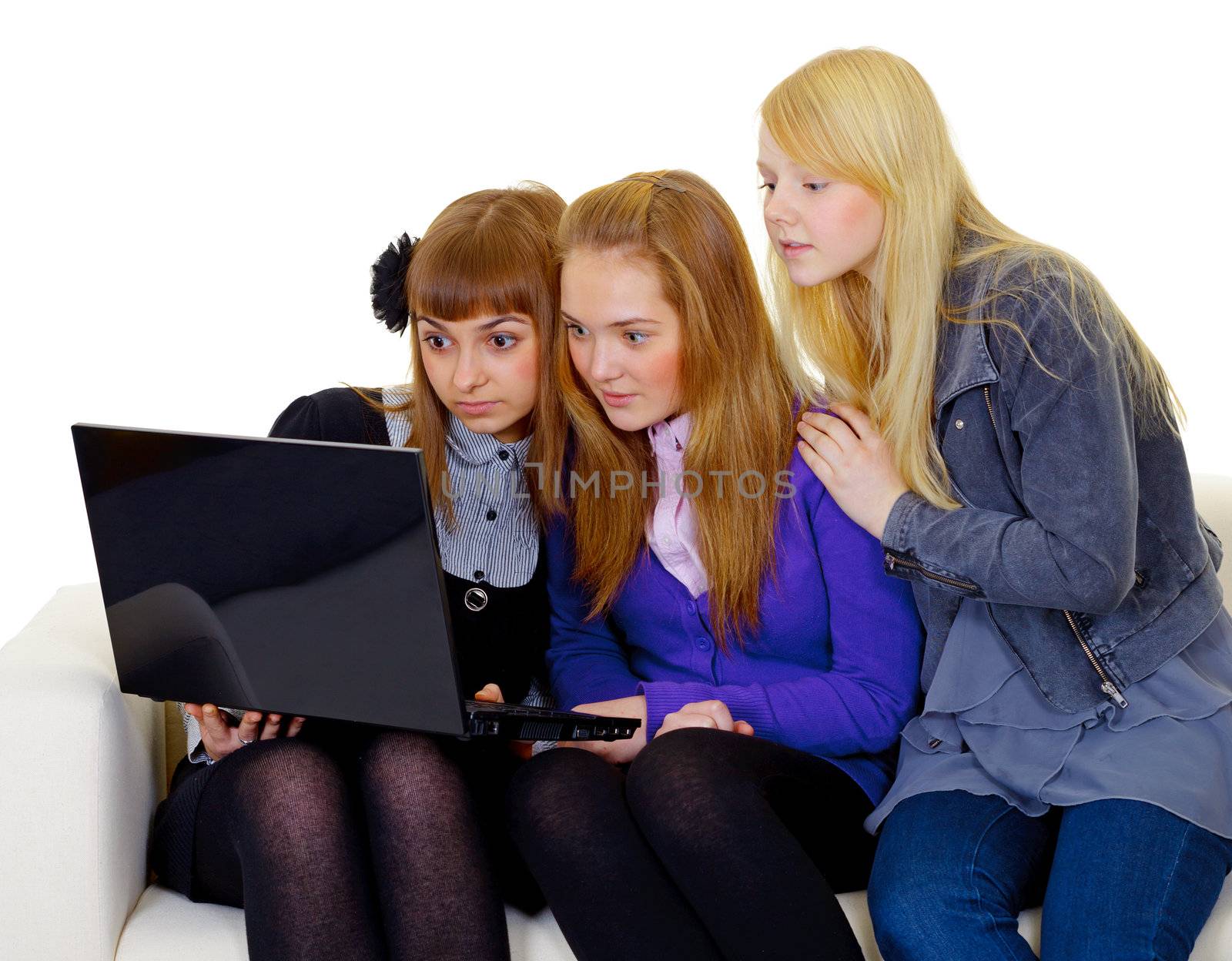 Concerned teenager girls with a black laptop isolated on white background