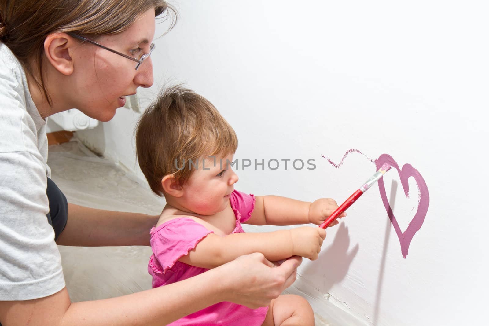 Little girl paint on a board