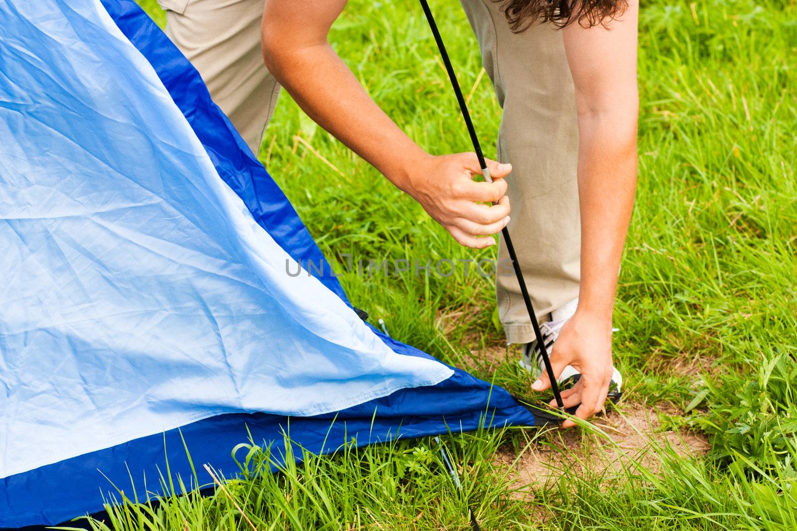 Putting up tent in a camping