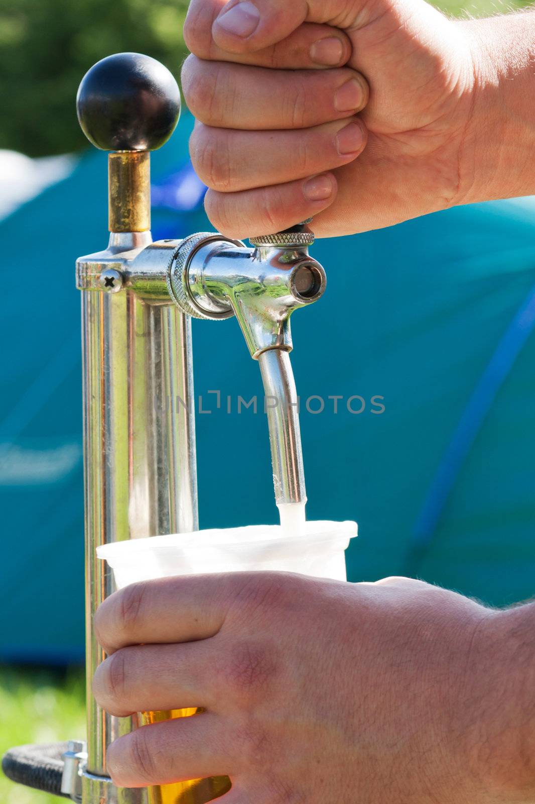 Man filling a glass of beer