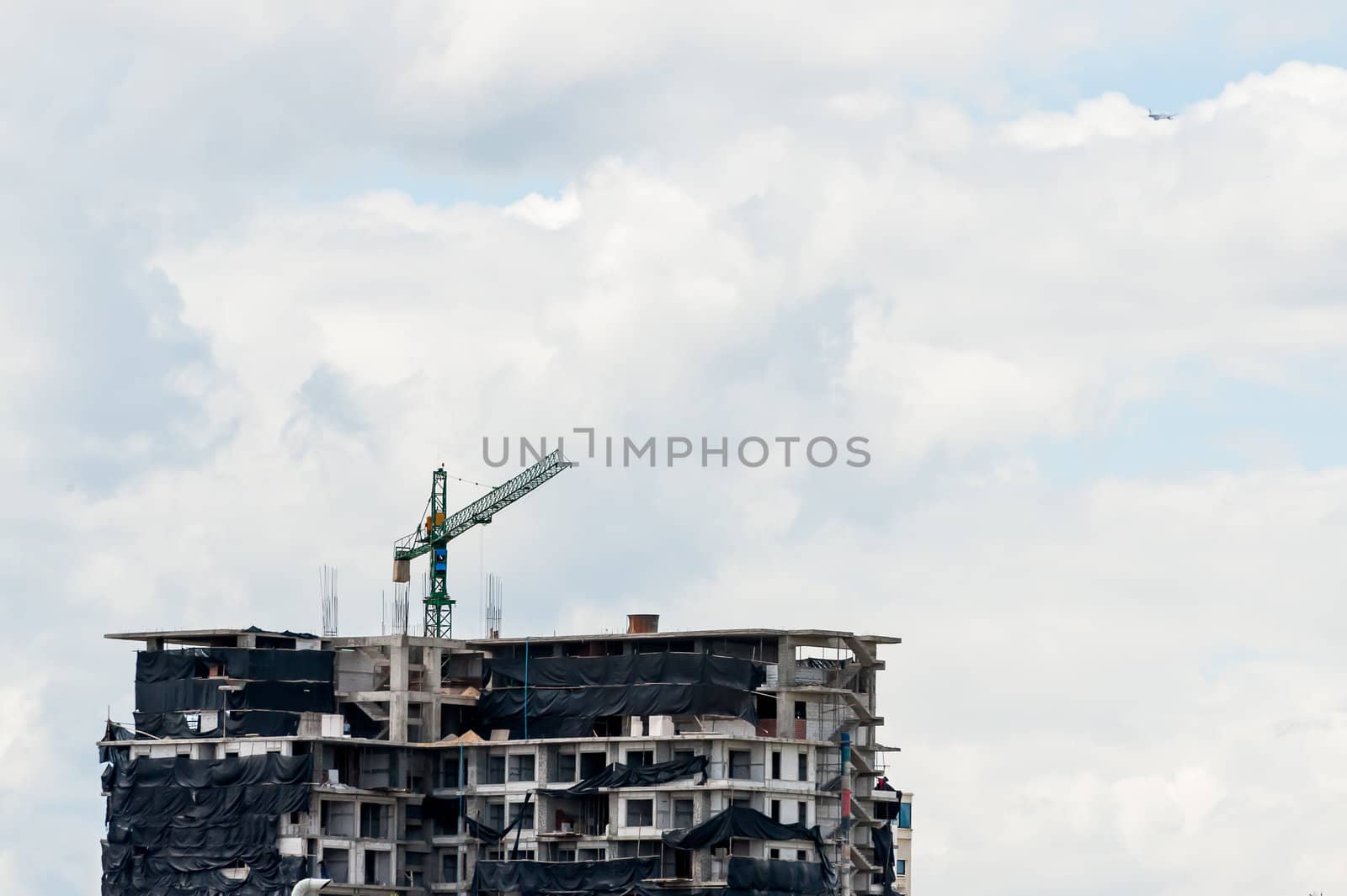 crane in construction site building  in evening time with cloud